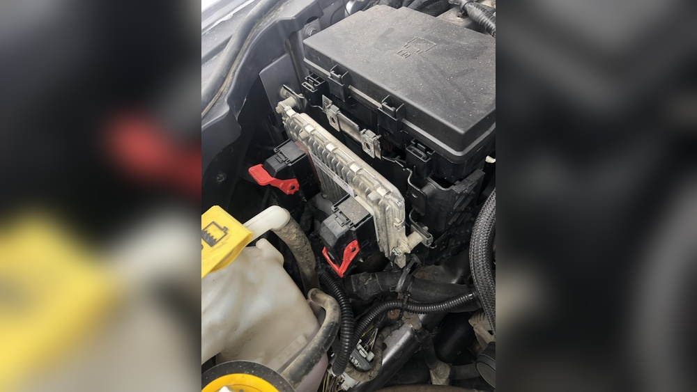 where is battery on 2015 jeep grand cherokee